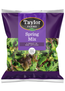 The Taylor Farms Spring Mix Salad in a purple bag, a medley of baby lettuces that is triple-washed and ready to eat.