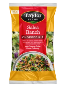 The Salsa Ranch Chopped Salad Kit package, showing romaine lettuce, red and green cabbage, kale, carrots, and green onions, which are topped off with shredded cheese, tortilla strips, and a salsa ranch dressing.