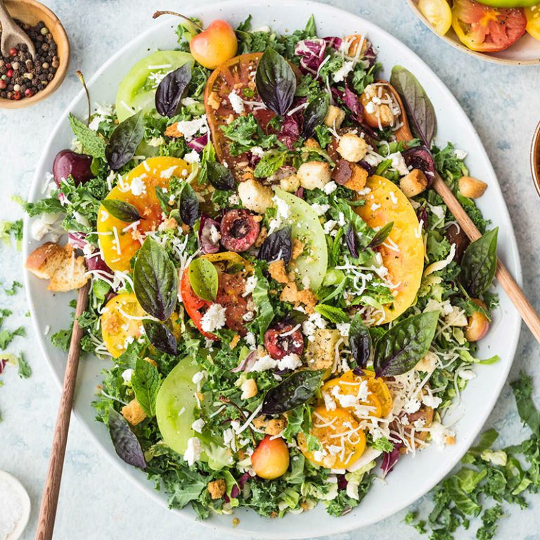 Fresh kale salad with colorful vegetables and dressing, perfect for healthy meals and nutrition.