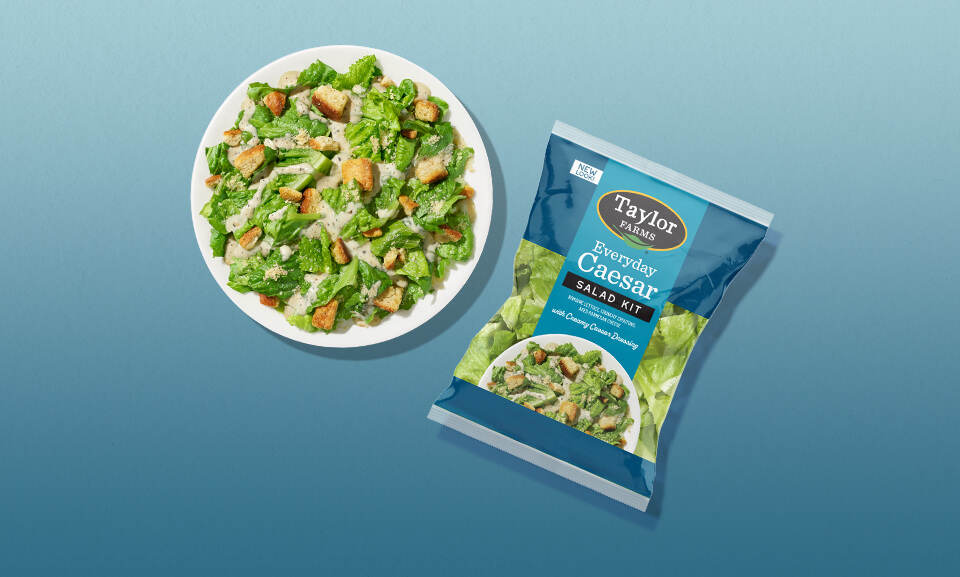 Fresh Everyday Caesar Salad Kit with leafy greens, croutons, and dressing on a plate, perfect for a quick, healthy meal.