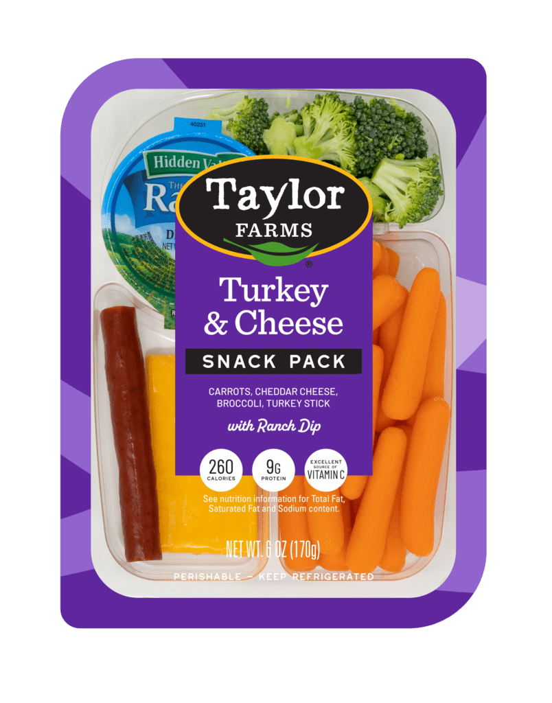 Taylor Farms Turkey & Cheese Snack Pack with turkey sticks, cheddar cheese, carrots, and broccoli.