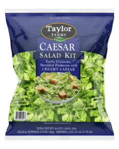 The Taylor Farms Caesar Salad Kit with chopped Romaine lettuce, bite-size croutons, shredded parmesan cheese, and creamy Caesar dressing.