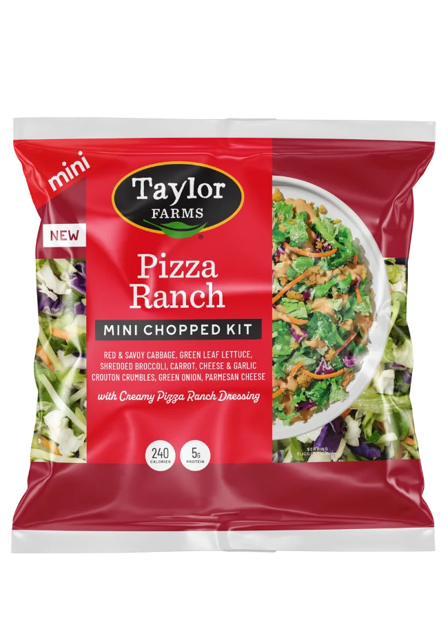 The Taylor Farms Pizza Ranch Mini Chopped Salad Kit package, showing red and savoy cabbage, green leaf lettuce, shredded broccoli, carrots, green onions, cheese and garlic crouton crumbles, parmesan cheese, and creamy Pizza Ranch Dressing.