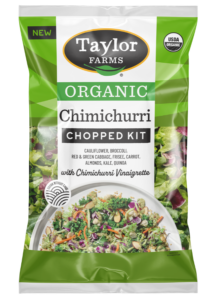 The Organic Chimichurri Chopped Salad Kit package with green leaf lettuce, organic green & red cabbage, broccoli, cauliflower, chicory, carrots, kale, toasted quinoa & sliced almonds, with chimichurri vinaigrette