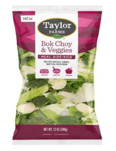 The Taylor Farms Bok Choy & Veggies package, showing chopped bok choy, broccoli, cabbage, snap peas, and green onion.