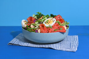 Taylor Farms Everything Lox Salad in a bowl on a blue background