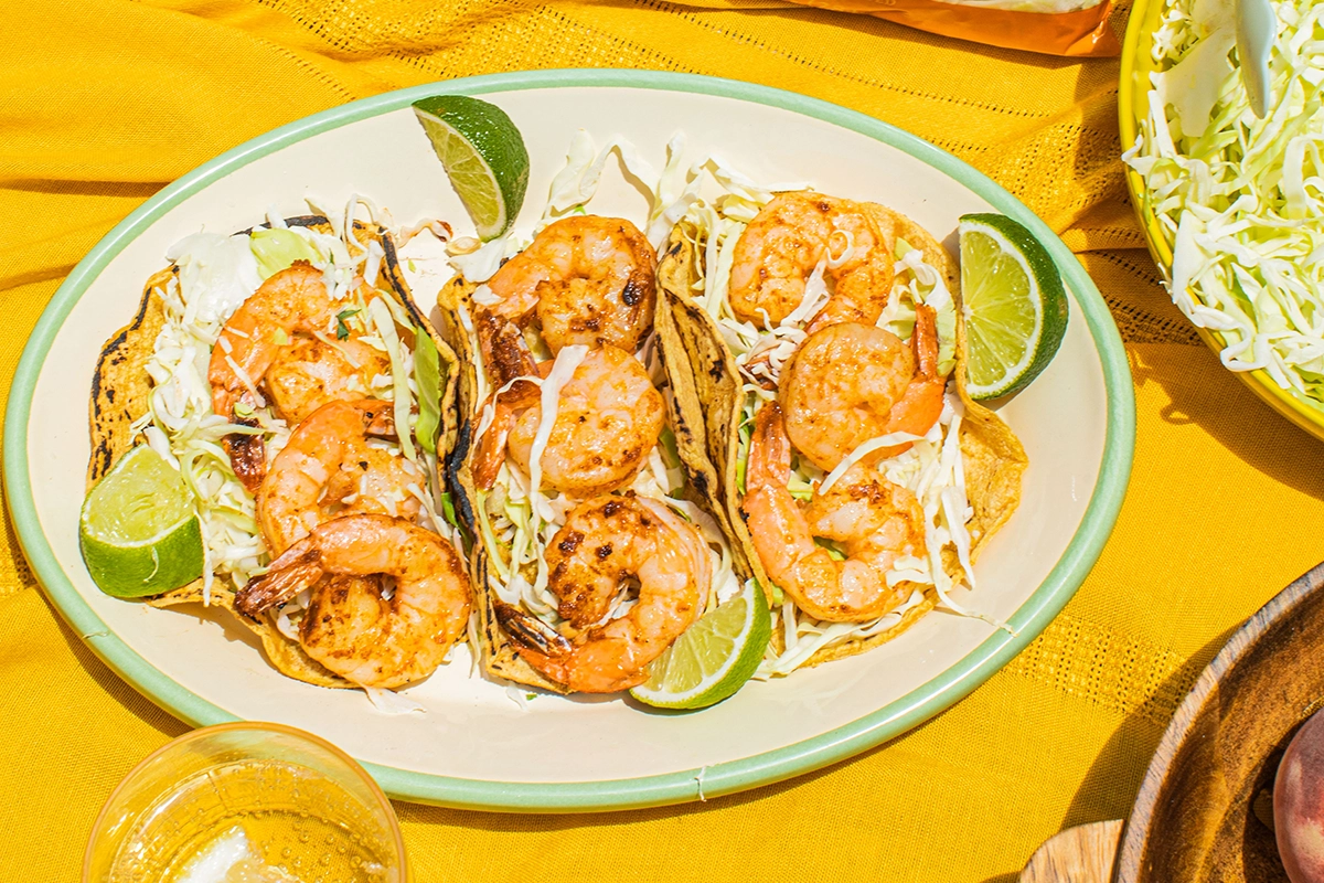 Shrimp tacos topped with crunchy coleslaw and fresh ingredients, perfect for a flavorful meal.