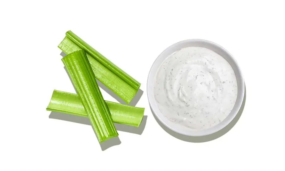 The Taylor Farms Celery Bites & Dip package, showing stalks of celery and a cup of ranch dip.