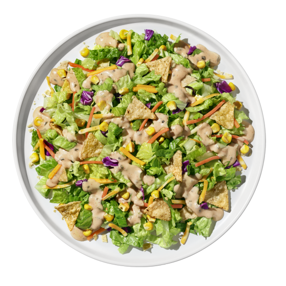 Chipotle ranch salad plated with fresh greens and colorful vegetables from Taylor Farms.