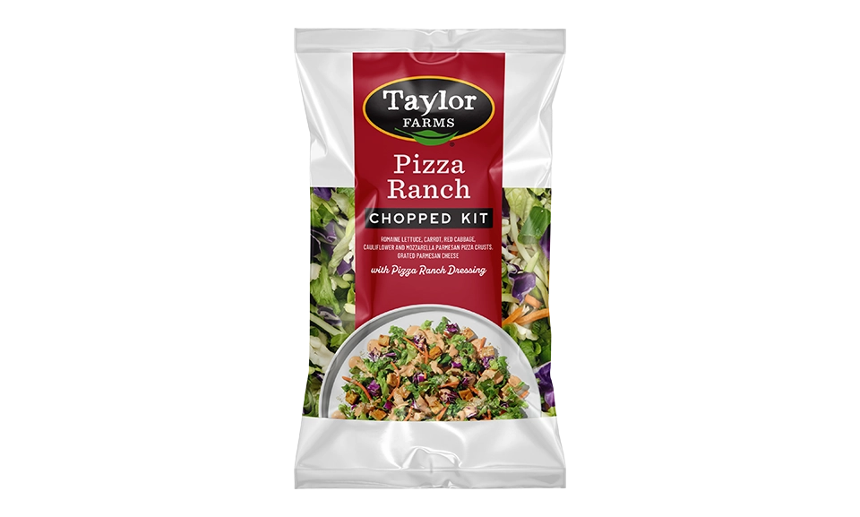 The Taylor Farms Pizza Ranch Chopped Kit package, showing chopped romaine lettuce, carrot, red cabbage, pizza crust pieces, grated parmesan cheese, and Pizza Ranch Dressing.