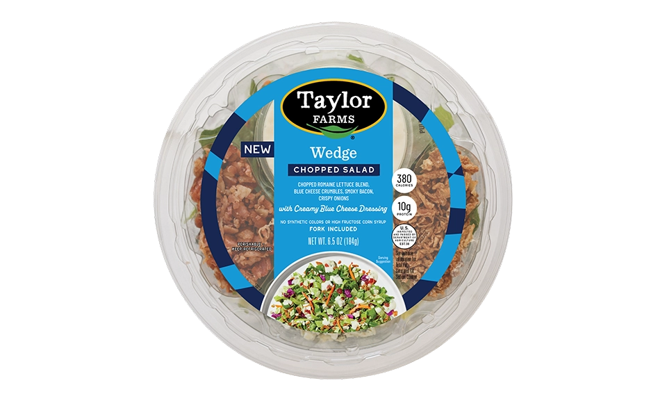 The Taylor Farms Wedge Chopped Salad Bowl package, showing romaine lettuce, red and green cabbage, carrots, bacon pieces, blue cheese crumbles, crispy onions, and creamy blue cheese dressing.