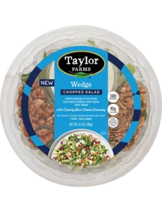 Taylor Farms Wedge Chopped Salad Bowl featuring fresh greens, tomatoes, and savory toppings in a convenient serving container.