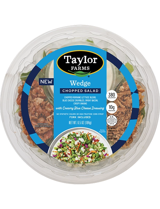 The Taylor Farms Wedge Chopped Salad Bowl package, showing romaine lettuce, red and green cabbage, carrots, bacon pieces, blue cheese crumbles, crispy onions, and creamy blue cheese dressing.