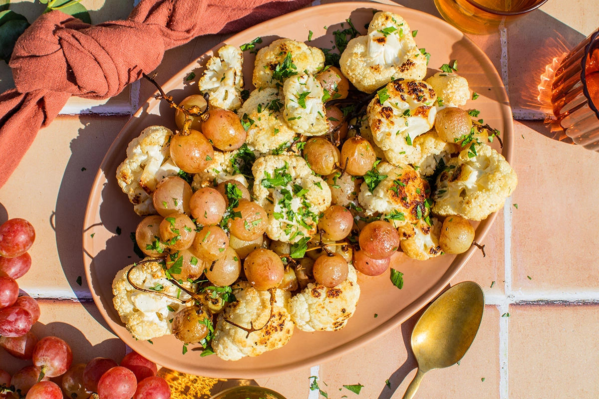 Roasted cauliflower and grapes served in a bowl, showcasing a colorful and nutritious dish ideal for healthy meals.