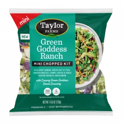 The Taylor Farms Green Goddess Ranch Mini Chopped Salad Kit package, showing red and savoy cabbage, green leaf lettuce, shredded broccoli, carrots, green onions, cheese and garlic crouton crumbles, and Green Goddess Ranch dressing.