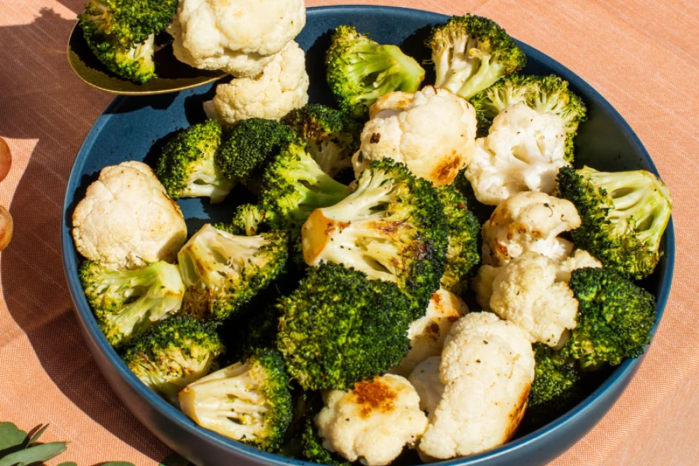 Roasted broccoli and cauliflower garnished with herbs, perfect for healthy meals and side dishes.