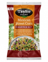 Taylor Farms Mexican Style Street Corn Chopped Salad Kit in a golden-colored pre-mixed package, showing the prepared salad with rows of corn, parmesan cheese, cornbread crumbles on a bed of green leaf lettuce with red cabbage and shredded carrots.