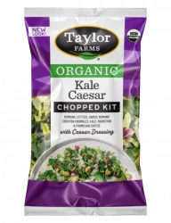 The Organic Kale Caesar Chopped Salad Kit with romaine, kale, radicchio, parmesan cheese, garlic romano crouton crumbles, and creamy Caesar dressing inside.