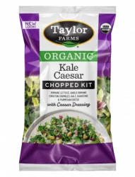 The Organic Kale Caesar Chopped Salad Kit with romaine, kale, radicchio, parmesan cheese, garlic romano crouton crumbles, and creamy Caesar dressing inside.